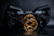 Close-up of a black and gold wheel hub attached to a GSI X-29 on a dark background